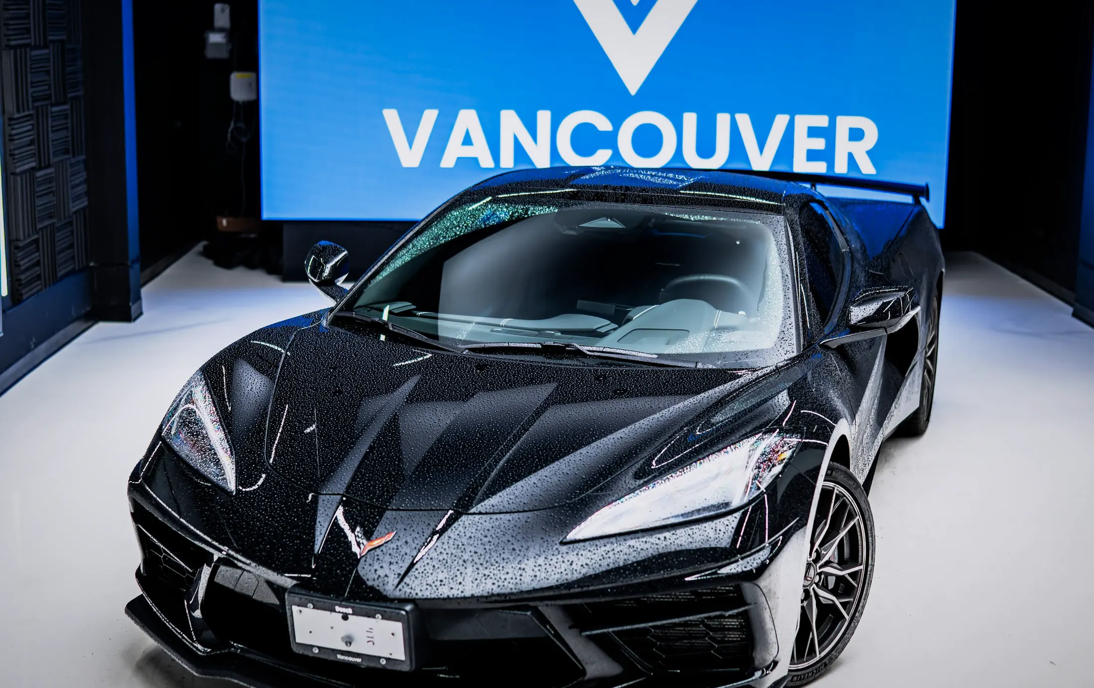 Chevrolet Corvette C8 with the roof panel removed on Marine Drive, West Vancouver, at sunset