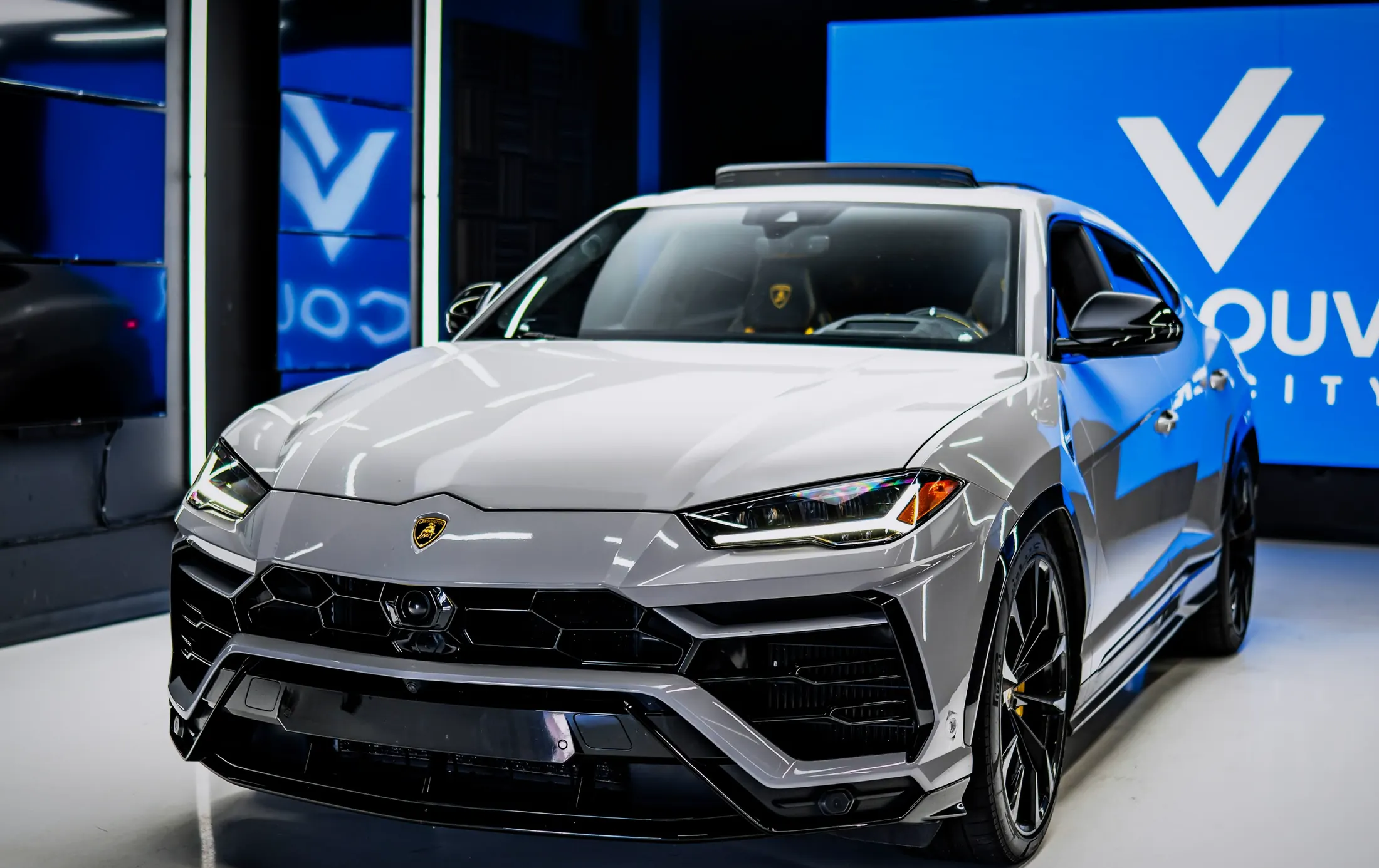 Lamborghini Urus parked along Coal Harbour in Vancouver at blue hour
