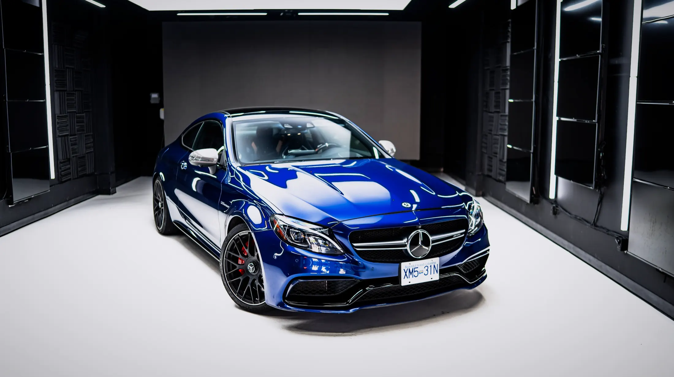 Mercedes-AMG C63 S on Marine Drive in West Vancouver with the ocean and Lions Gate Bridge in view