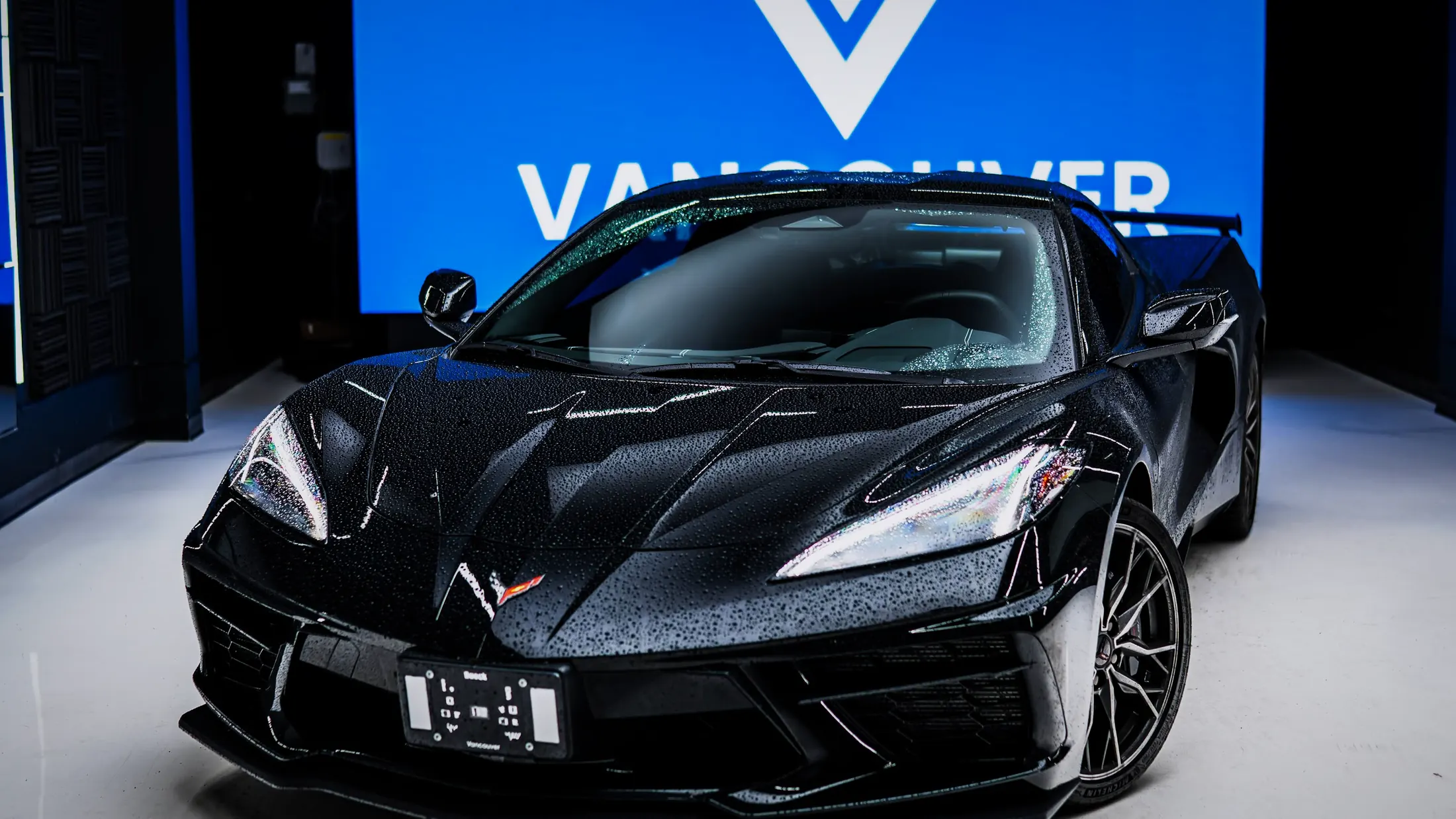 Chevrolet Corvette C8 with the roof panel removed on Marine Drive, West Vancouver, at sunset