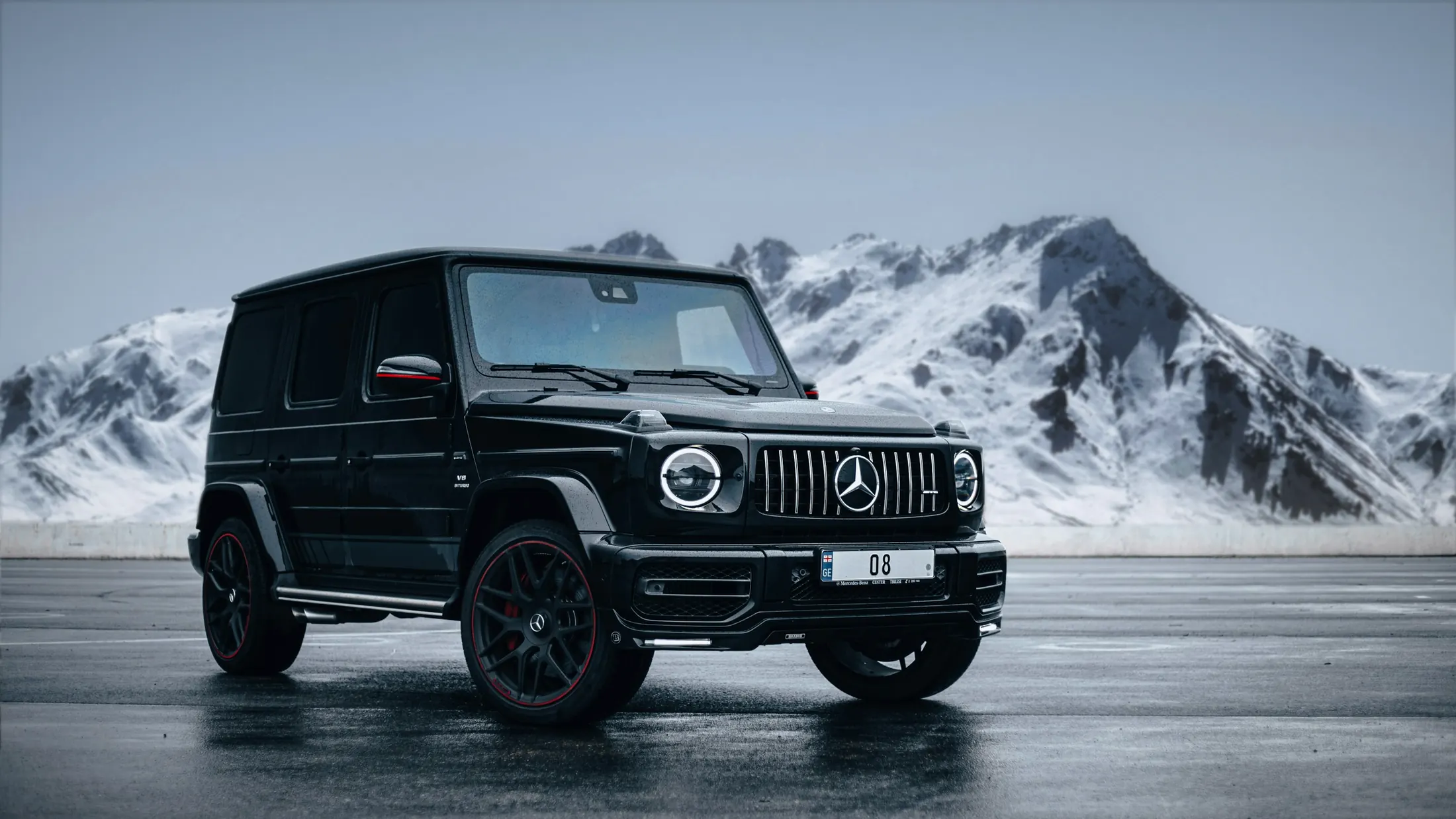 Mercedes-AMG G63 on a wet road in North Vancouver with forested mountains behind