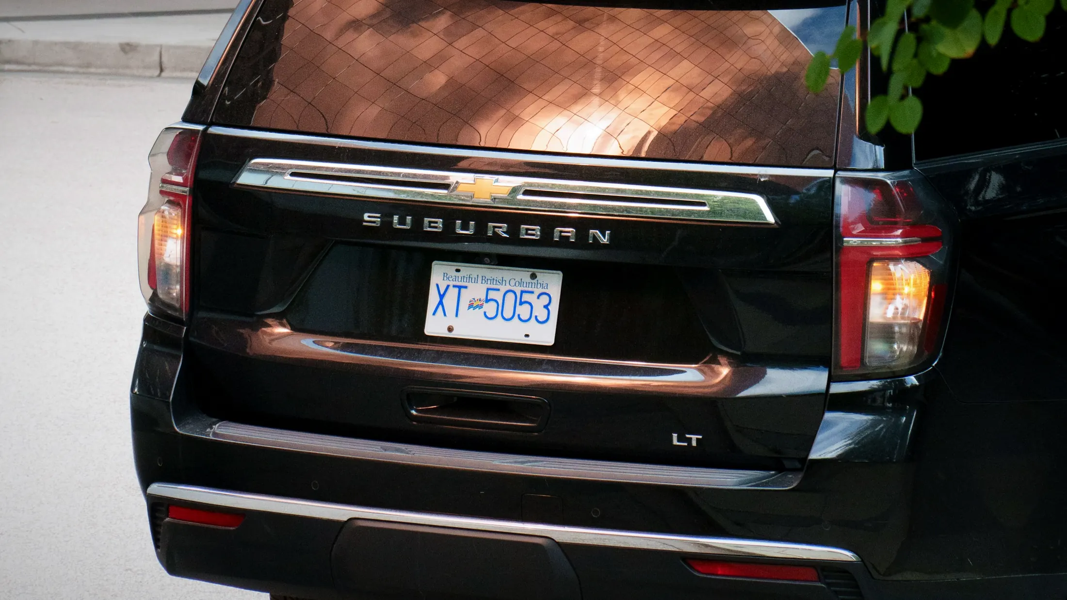 Chevrolet Suburban RST loaded with ski bags outside a lodge in Whistler Village