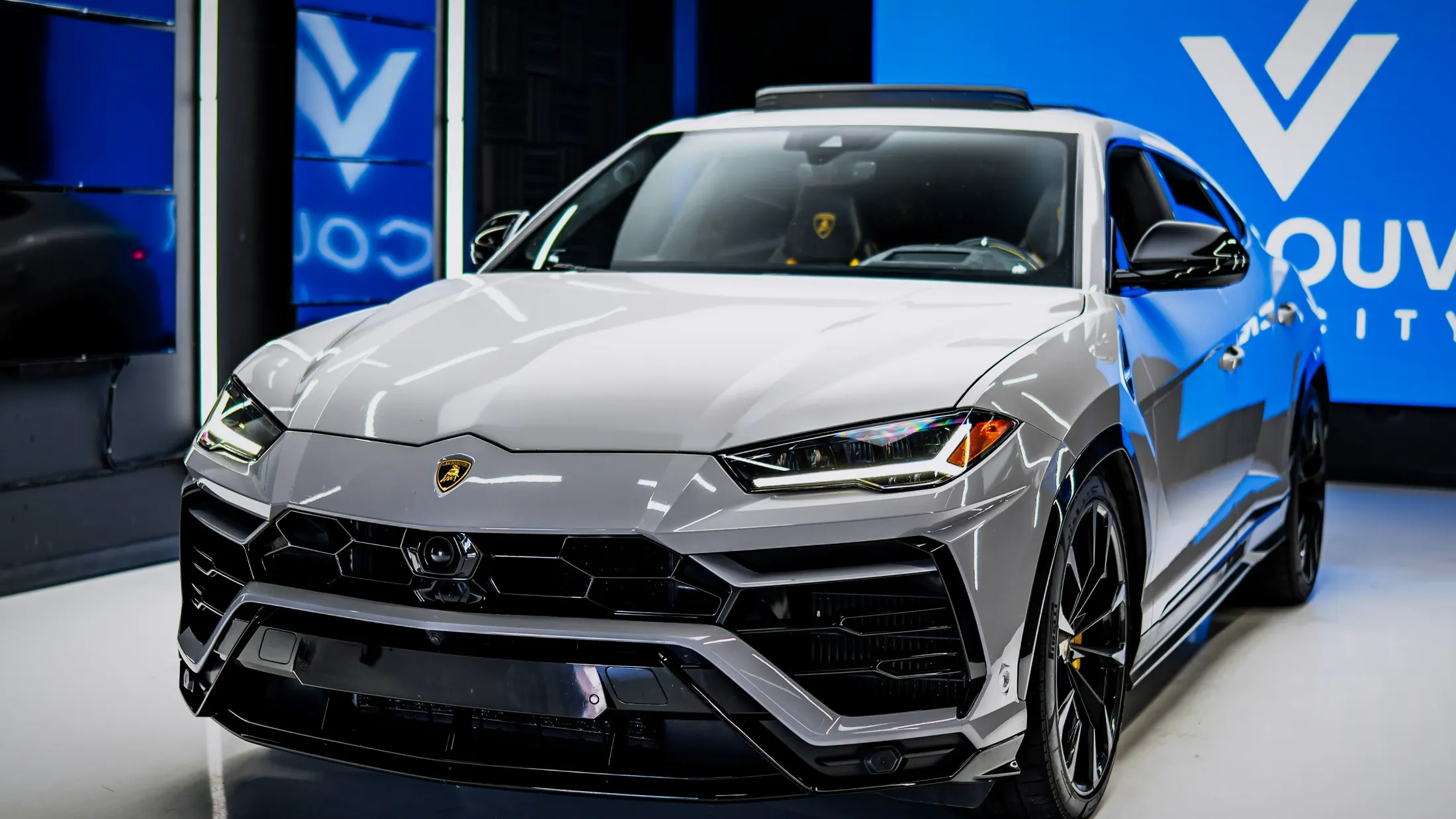 Lamborghini Urus parked along Coal Harbour in Vancouver at blue hour